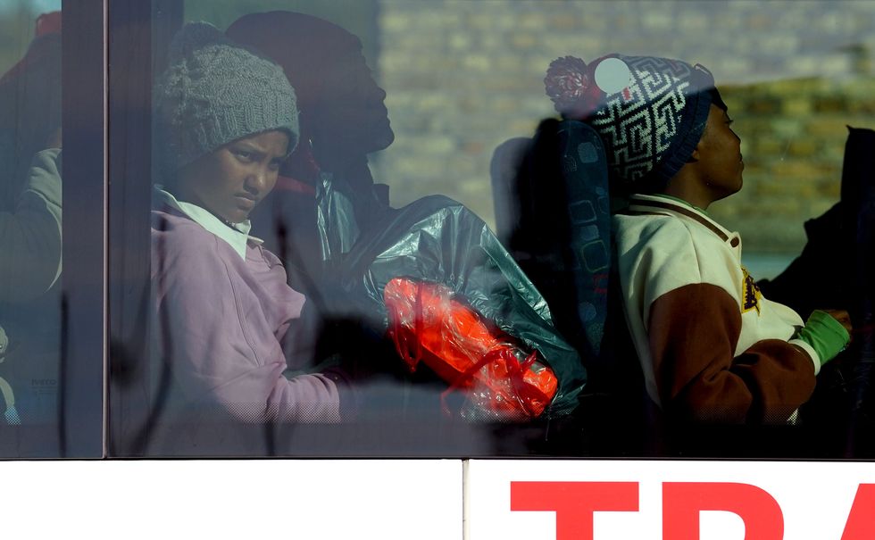 Migrants who arrived in Dover are placed onto a bus