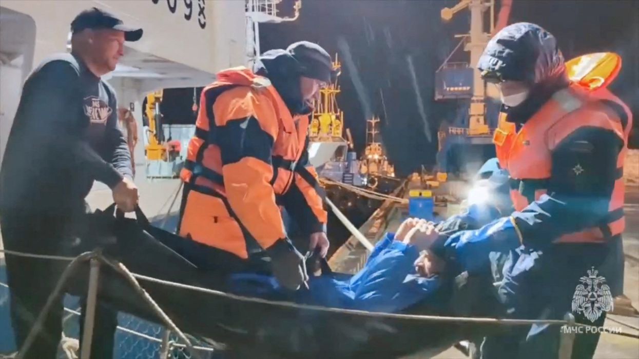 Mikhail Pichugin being taken to safety