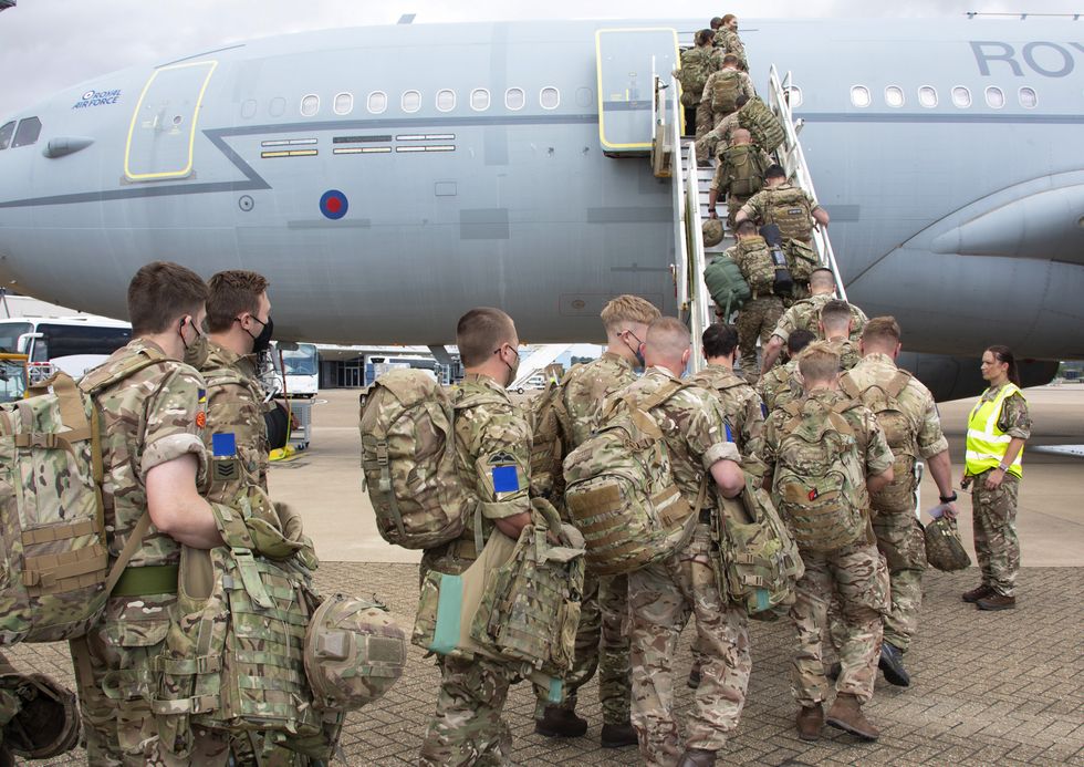 Military personnel boarding an RAF Voyager aircraft at RAF Brize Norton, as around 8,000 British Army troops will take part in exercises across eastern Europe to combat Russian aggression in one of the largest deployments since the Cold War.