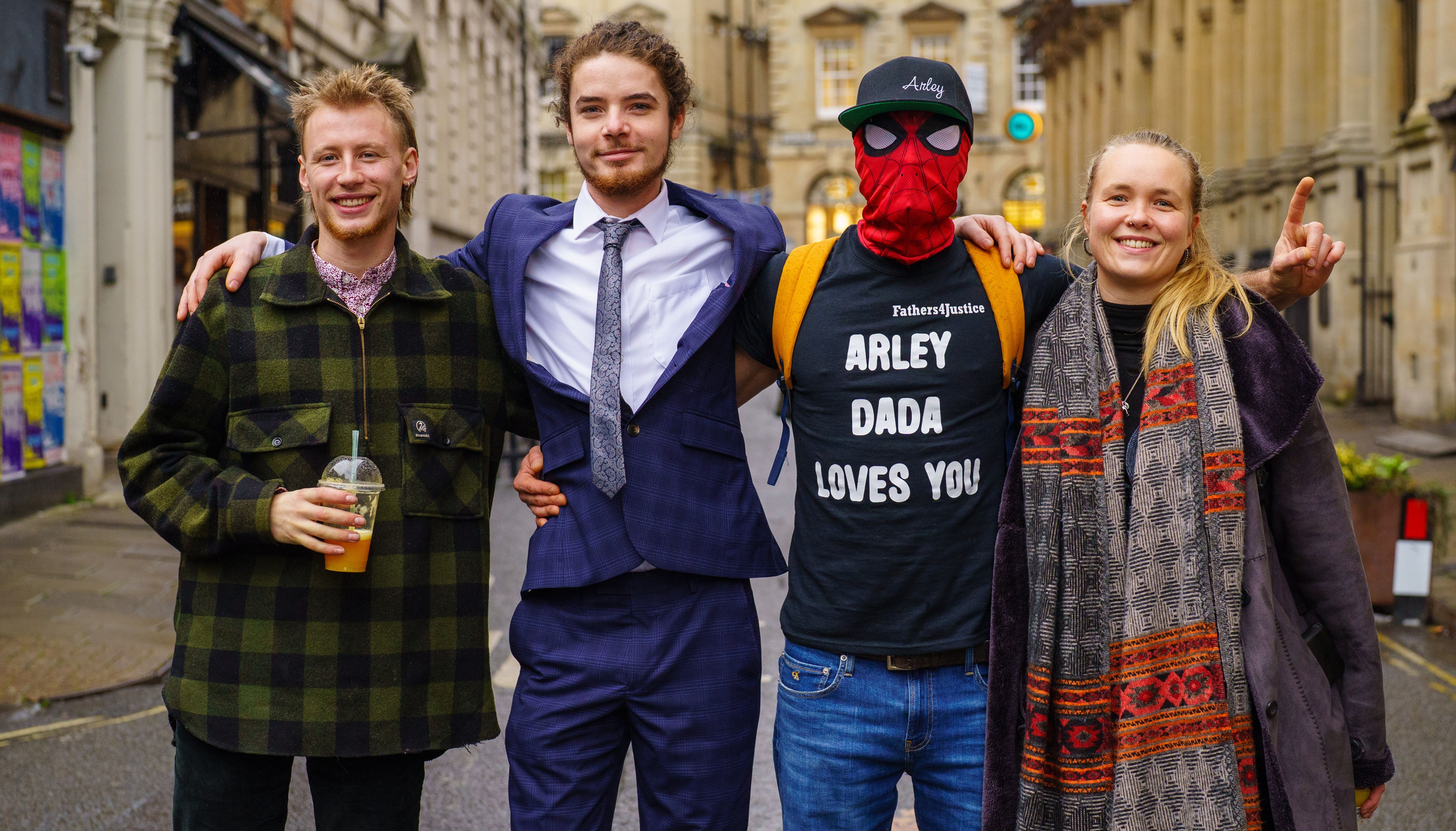 Milo Ponsford, left, Sage Willoughby, second left, Jake Skuse , second right in mask, and Rhian Graham right, accused of criminal damage over the toppling of the statue of slave trader Edward Colston, outside Bristol Crown Court.