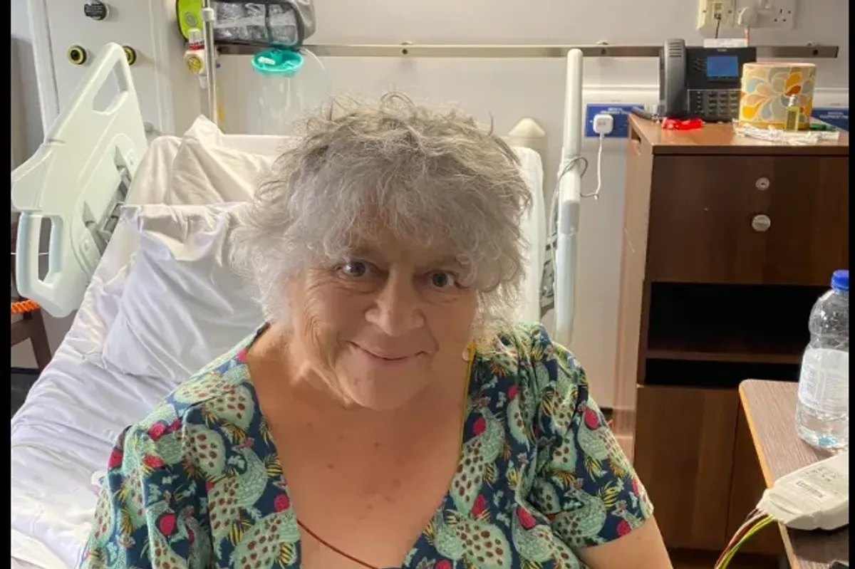 Miriam Margolyes smiles from her hospital bed