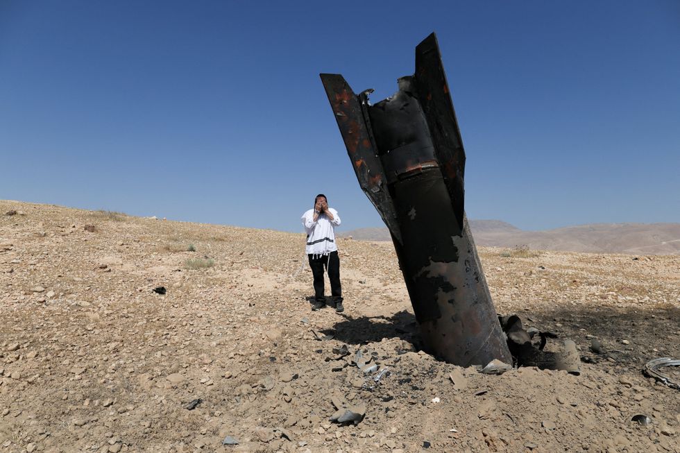 Missile protrudes from the ground in Israeli-occupied West Bank