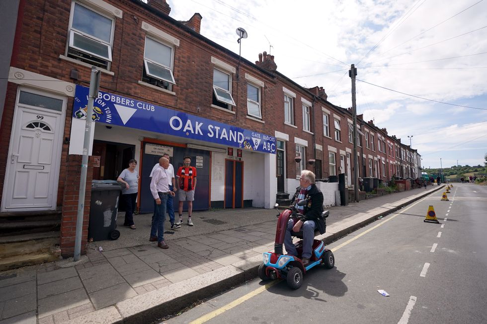 Mobility scooter driving past the Luton Town FC away end