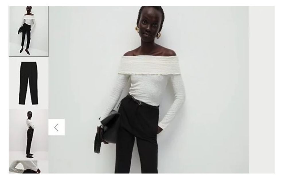 Model depicted wearing white off-shoulder top, black trousers, and oversized shoes in M&S ad