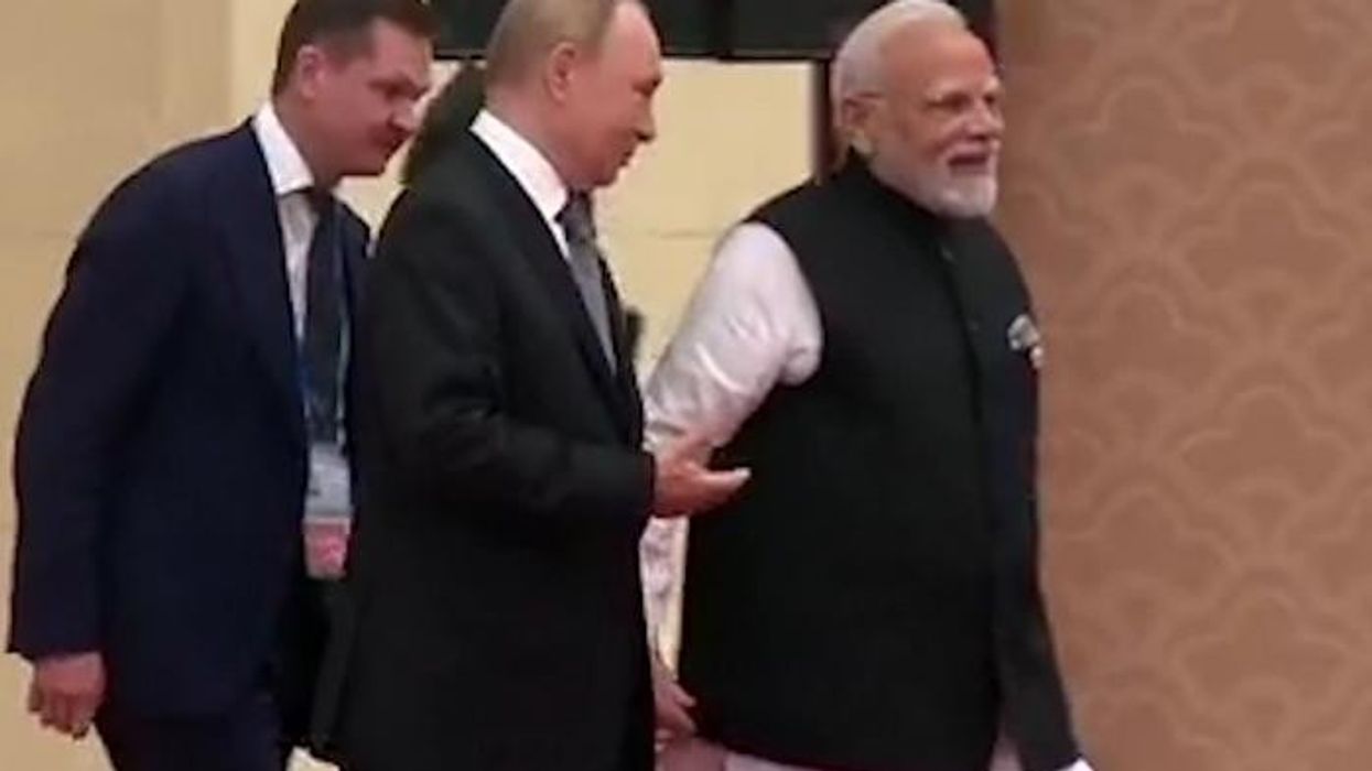 WATCH: Bizarre moment Vladimir Putin holds hands with Narendra Modi at anti-Nato summit