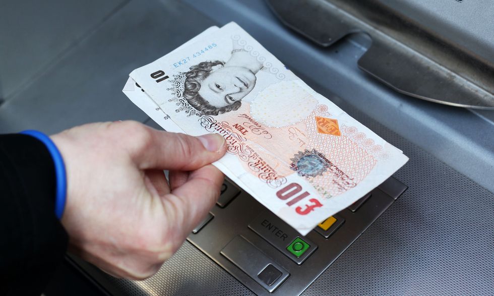 Money being taken out of a cash machine.