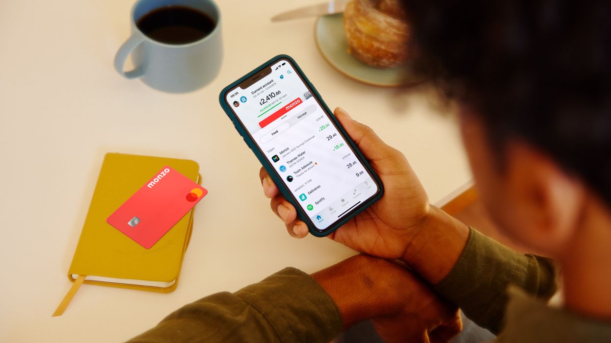 Monzo customer uses app beside bank card