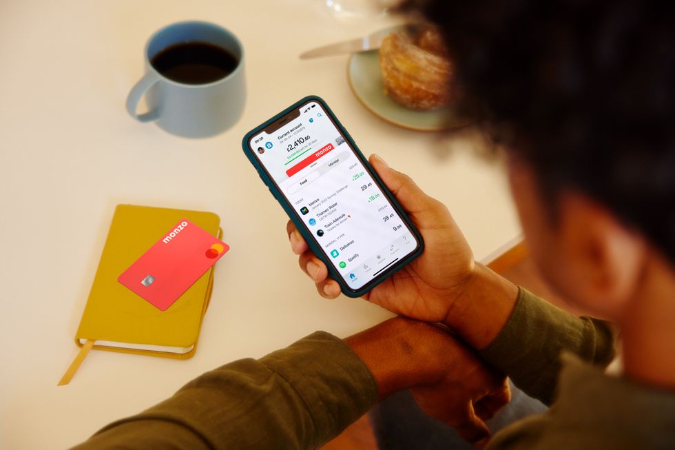 Monzo customer uses app beside bank card