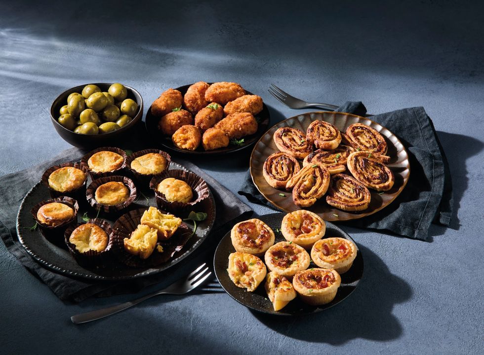 Morrisons' bite-sized snacks, including mini quiches, olives, potato skins on trays