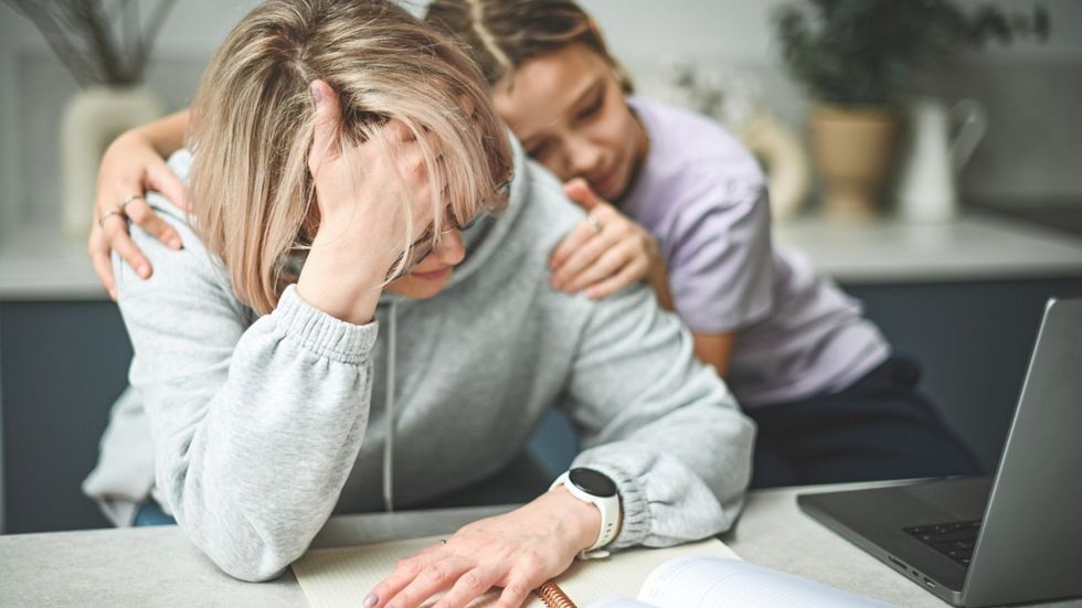 Mother and daughter looking stressed