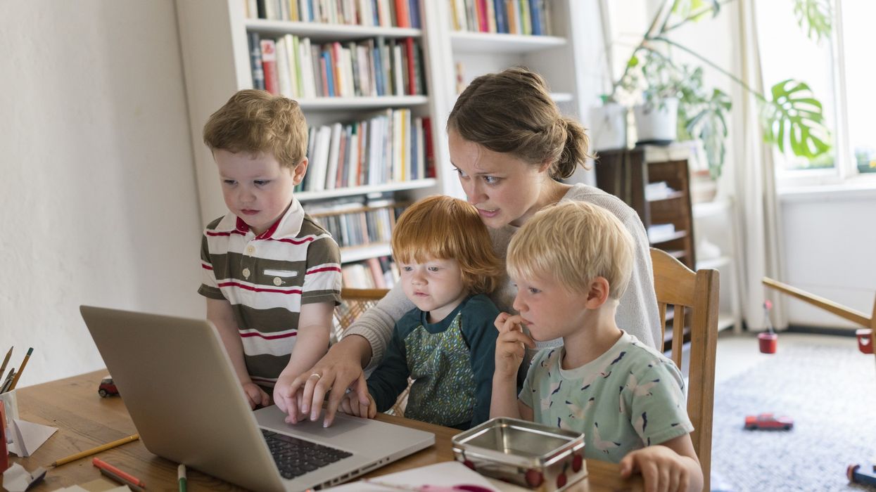 Mother at laptop with kids