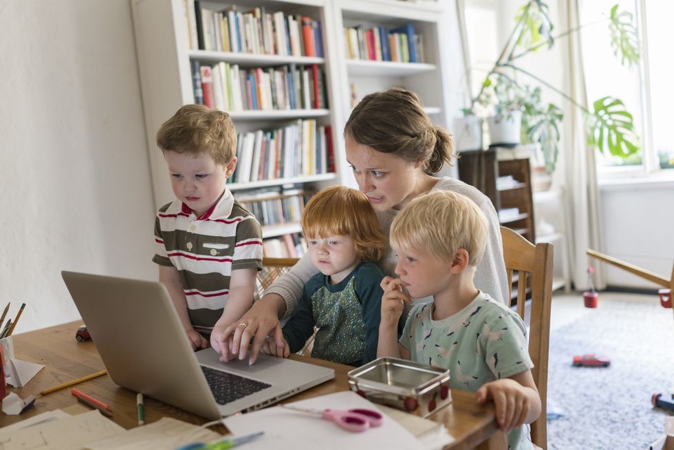Mother at laptop with kids