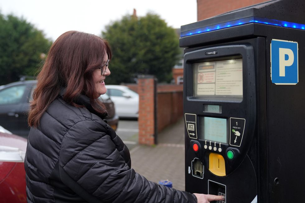 Motorist Debbie Dinckal at a payment machine in Syston Town Square car park in Leicestershire