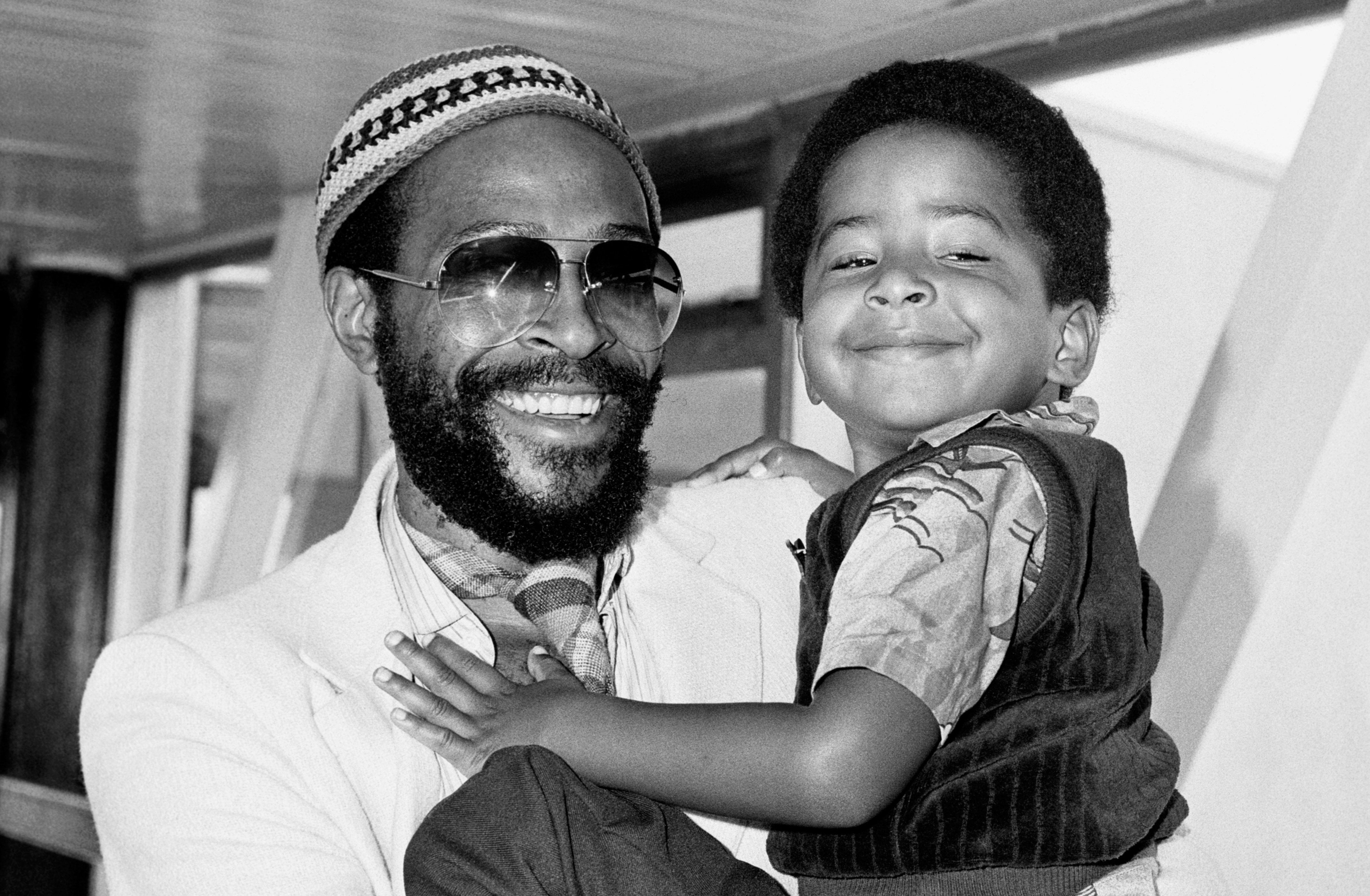 Motown recording star, Marvin Gaye, holding his happy looking four year old son Frankie, on their arrival at London's Heathrow airport from San Francisco. Marvin is here for a British and European concert tour starting at London's Royal Albert Hall.