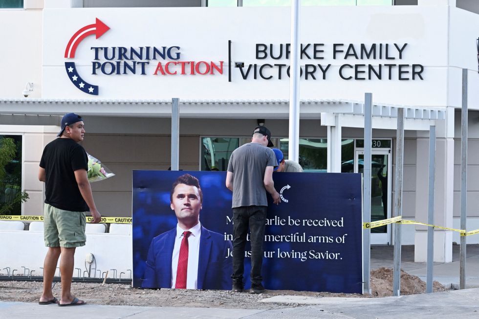 Mourners bring flowers to a memorial for Charlie Kirk, who was shot and killed in Utah, outside Turning Point in Phoenix, Arizona