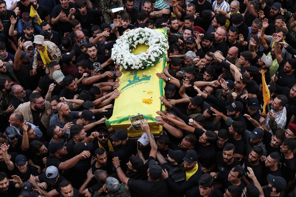 Mourners gather at the funeral of Hezbollah members Fadel Abbas Bazzi and Ahmad Ali Hassan