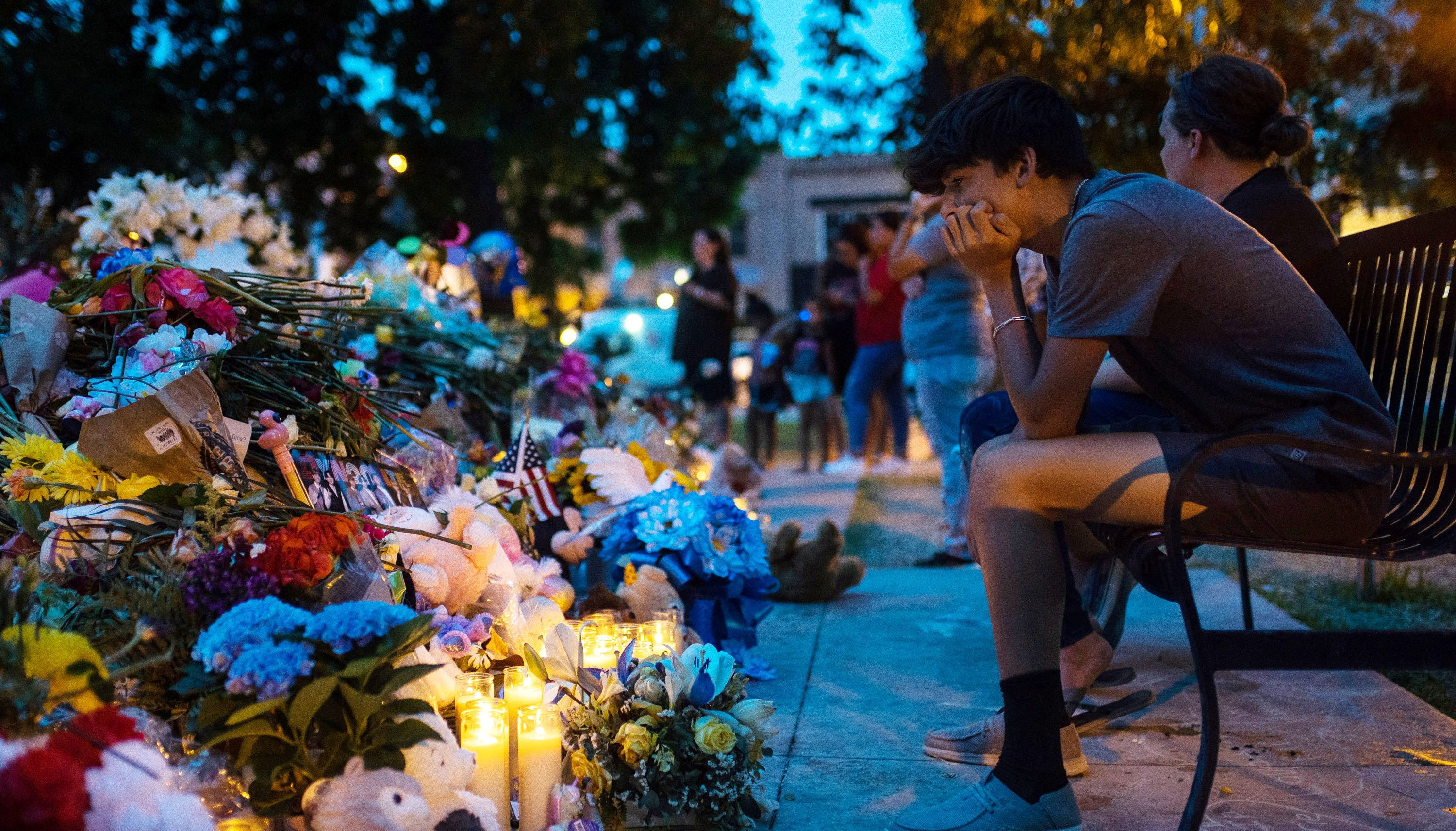 Mourners pay their respects at a memorial for the 21 killed in the mass shooting at Robb Elementary School, in the Uvalde Town Square in Uvalde, Texas.