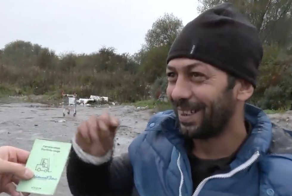 Mr Mohammad shows off his forklift license
