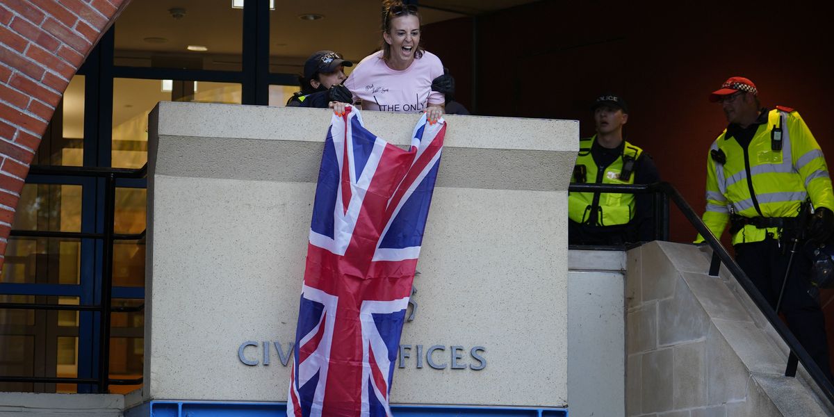 NextImg:Police drop charges against woman who unfurled Union Jack from Epping council building during migrant hotel protest