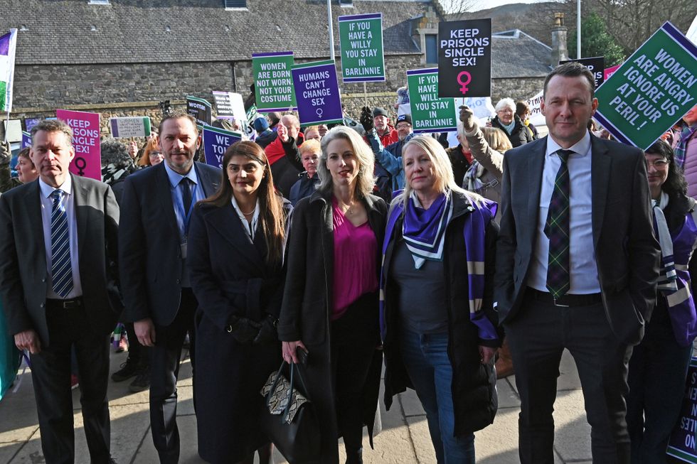 MSPs join organisers of women's rights groups at a protest outside the Scottish Parliament,
