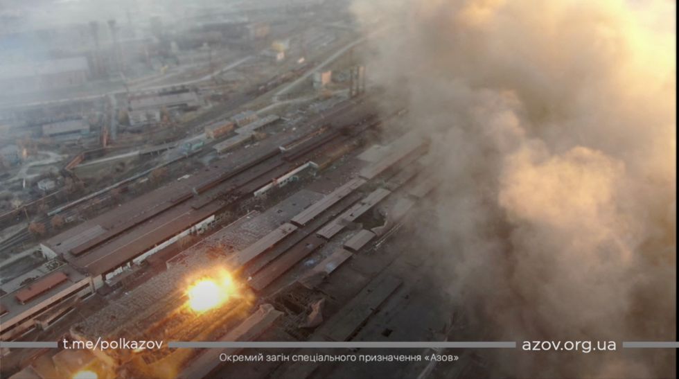 Multiple explosions and rising smoke are seen around an industrial compound, amid the Russian invasion of Ukraine, in Mariupol, in this screengrab from a video released on March 22, 2022. AZOV/Handout via REUTERS