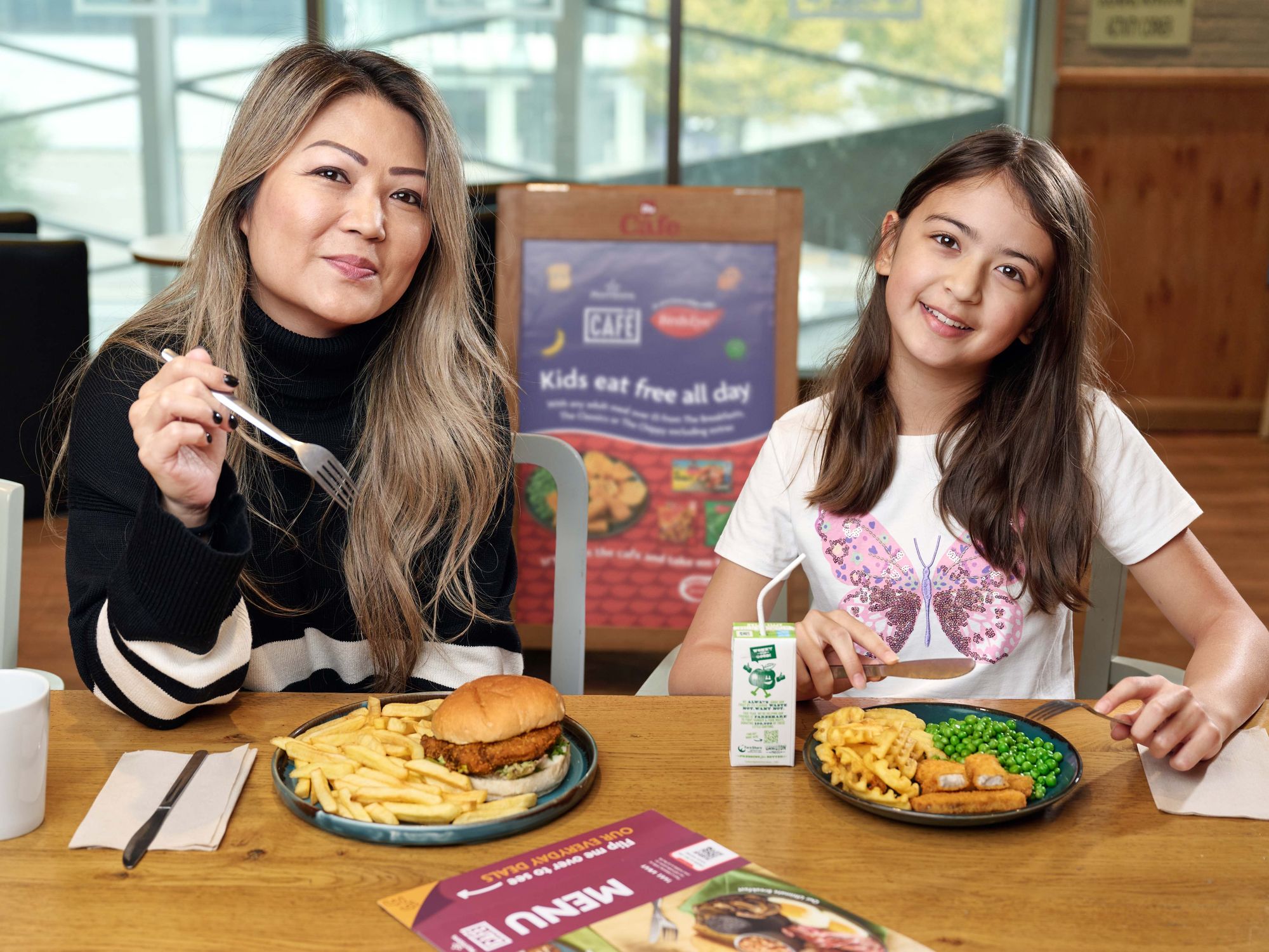Mum and daughter eating at Morrisons Café