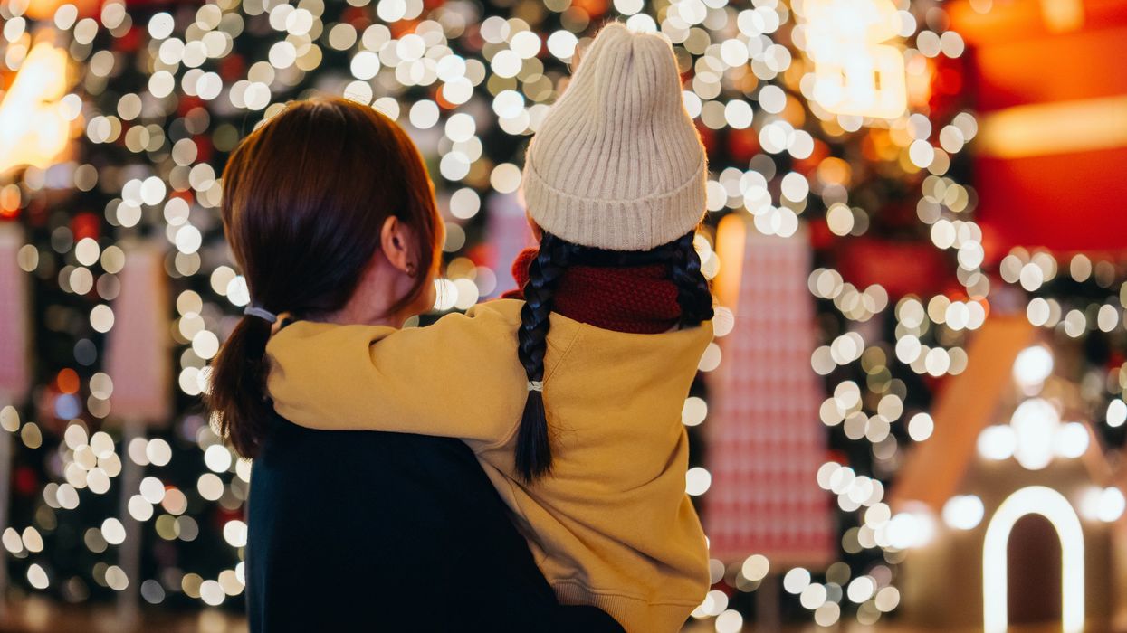 Mum and daughter looking at Christmas lights – festive scene