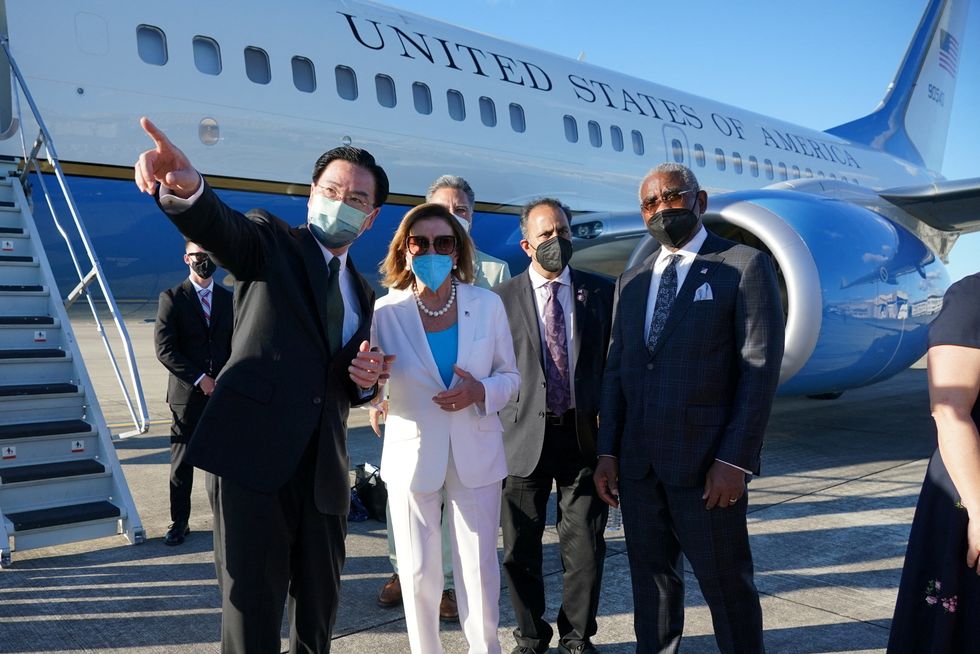 Nancy Pelosi talks with Taiwan Foreign Minister Joseph Wu before boarding a plane in Taipei