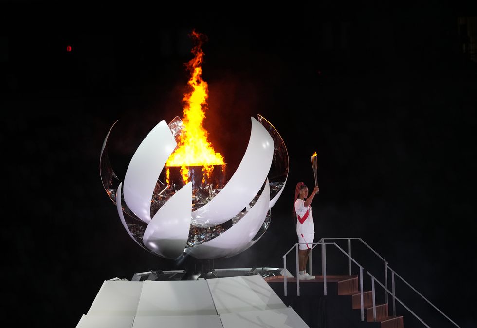 Naomi Osaka lights the Olympic flame during the opening ceremony of the Tokyo 2020 Olympic Games.