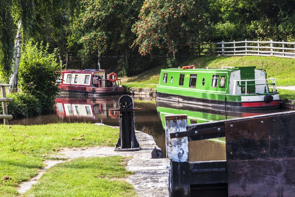 Narrowboats moored along the Monmouthshire and Brecon Canal at Llangynidr lock in the Brecon Beacons National Park