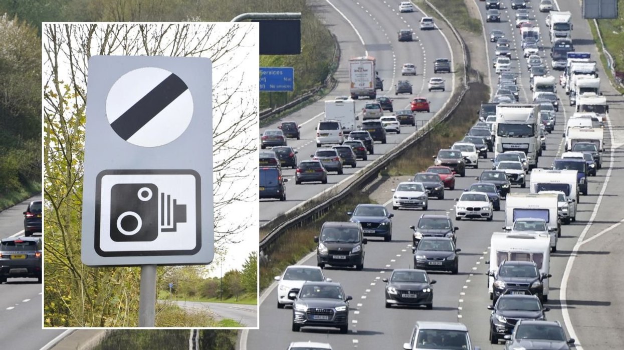 National speed limit sign and a busy motorway of traffic