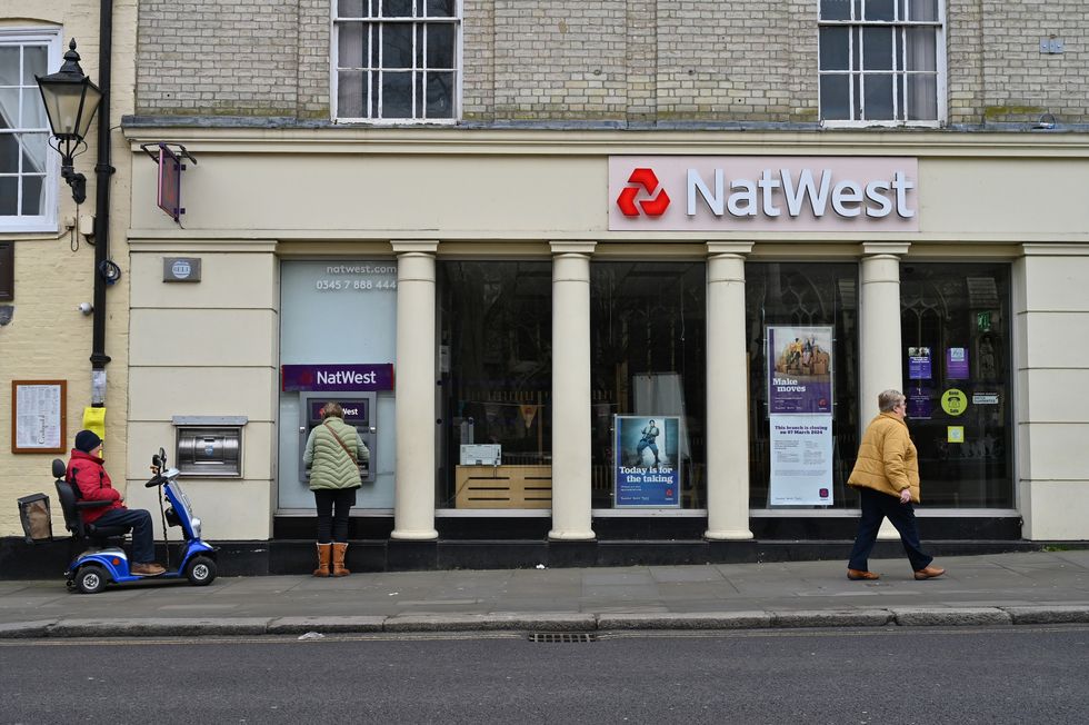 NatWest bank branch including person using free cash machine