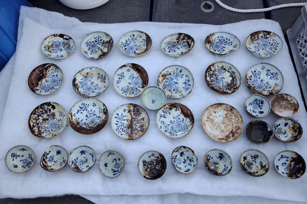 Neatly arranged blue-and-white porcelain bowls found