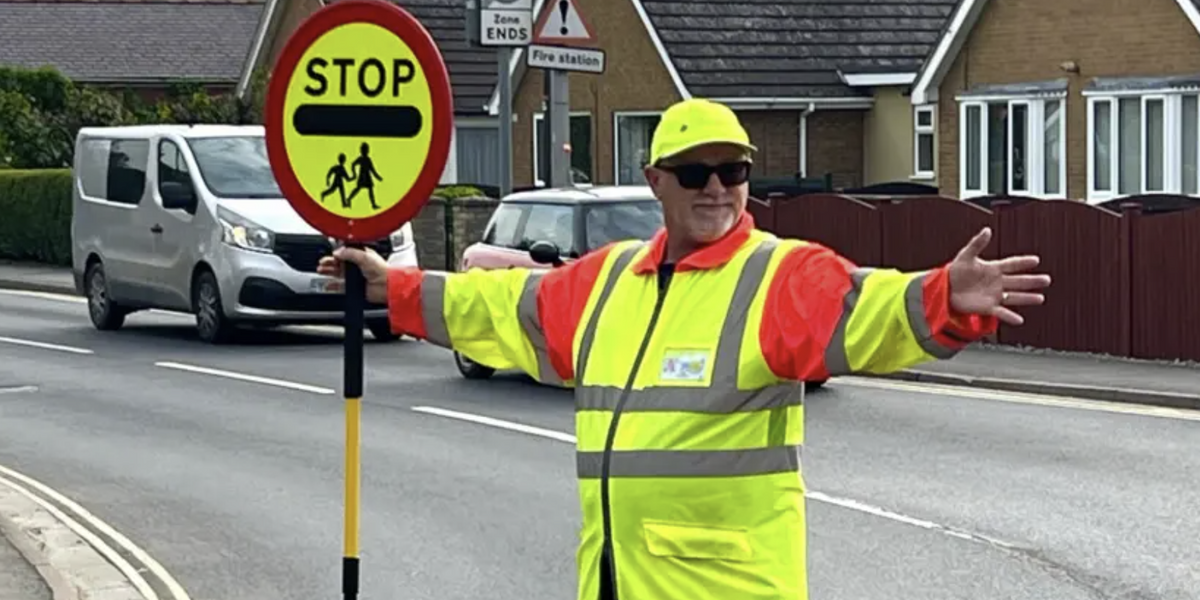 Council row erupts after lollipop man told to stop high-fiving schoolchildren as it delays drivers Council row erupts after lollipop man told to stop high-fiving schoolchildren as it delays drivers
