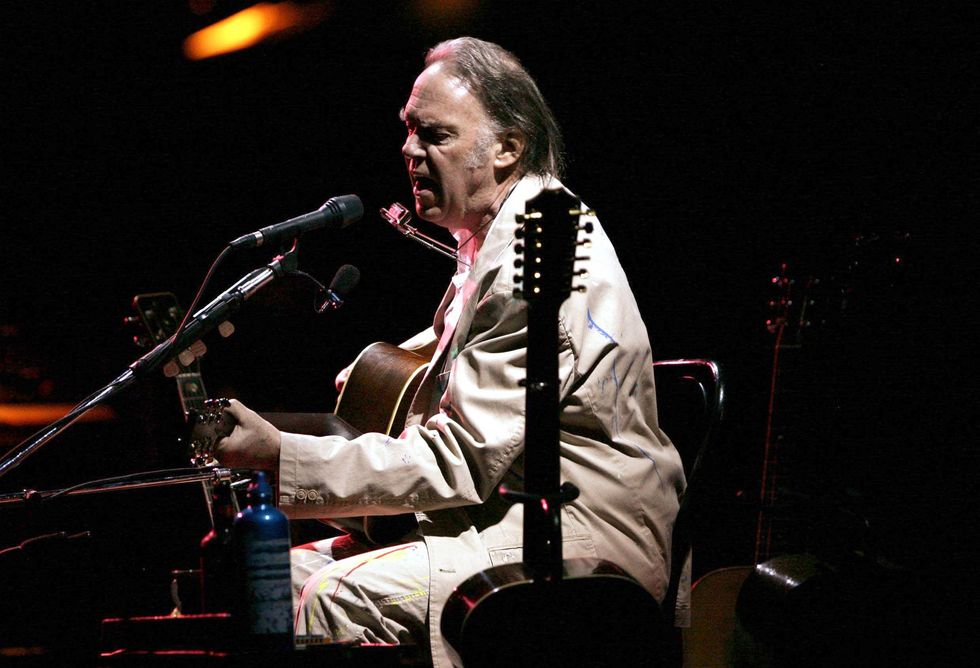 Neil Young performing the acoustic half of his concert at the Hammersmith Apollo in west London.
