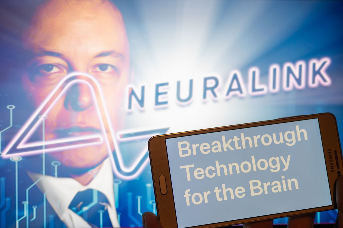 Neuralink logo displayed on mobile with founder Elon Musk seen on screen in the background