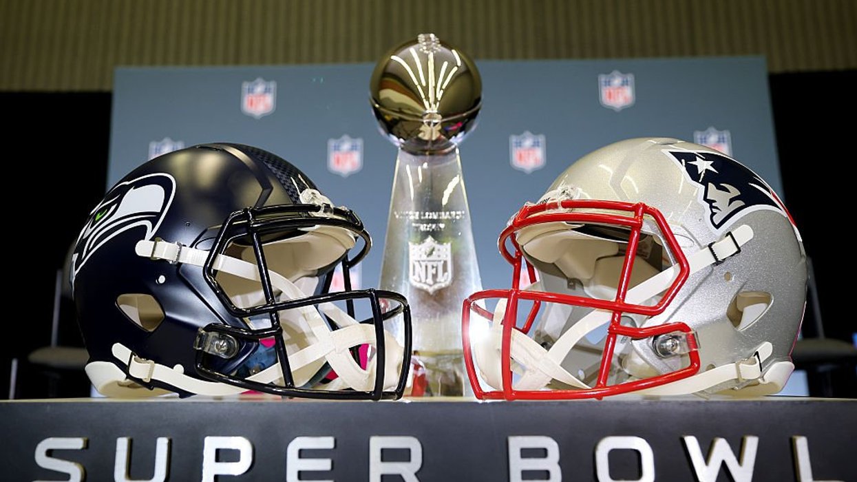 New England Patriots vs. Seattle Seahawks helmets in front of NFL Super Bowl trophy