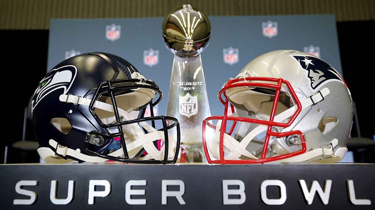 New England Patriots vs. Seattle Seahawks helmets in front of NFL Super Bowl trophy