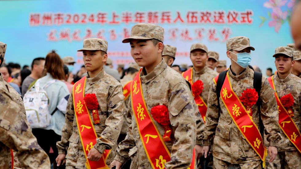 New soldiers are lining up at the railway station as they prepare to go to their barracks in Liuzhou