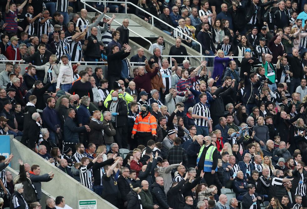 Newcastle United fans attract the attention of the officials to a medical emergency in the stands
