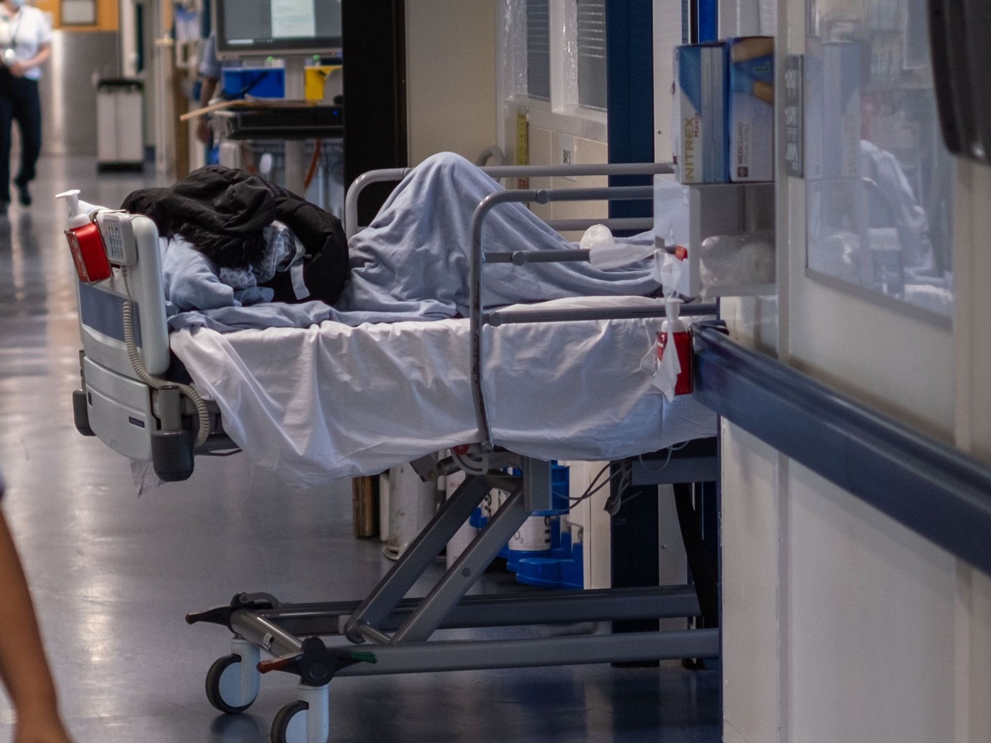 NHS patient being treated in a corridor