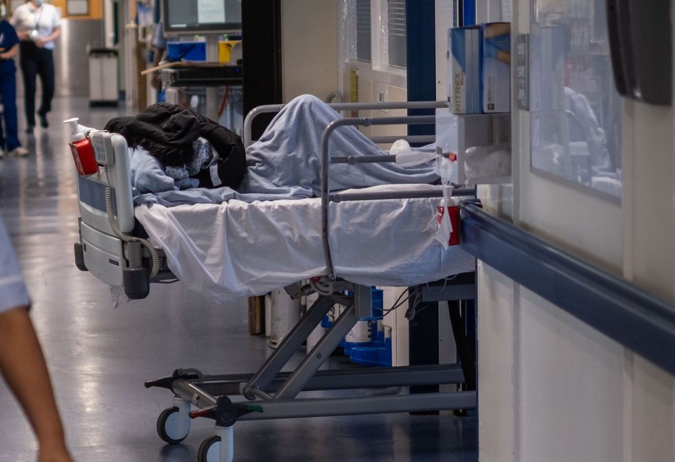 NHS patient being treated in a corridor