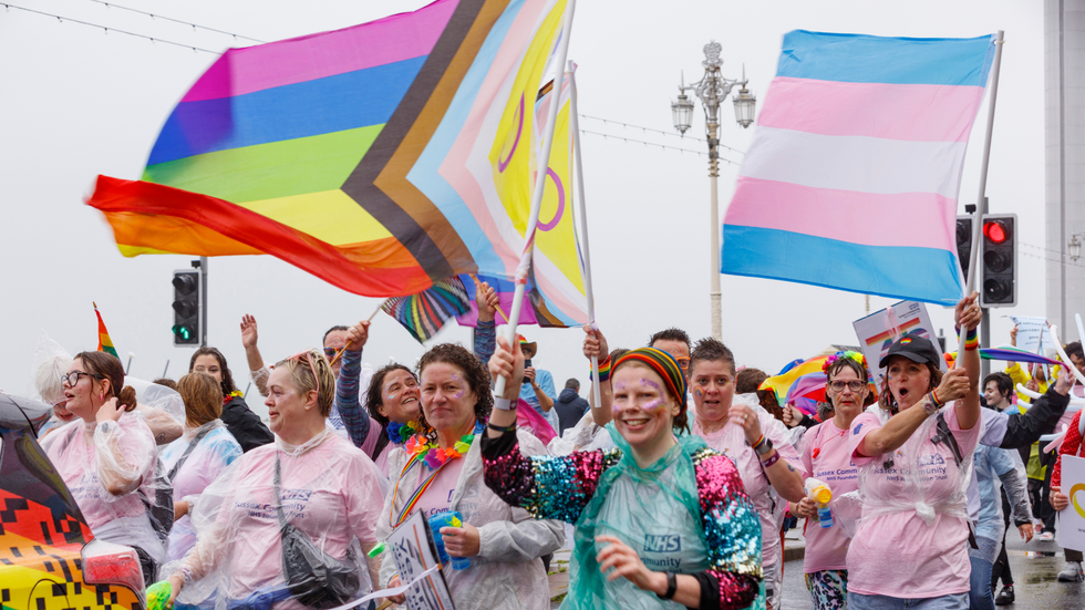 NHS workers hoisting the LGBTQ flag