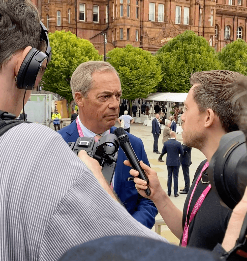 Nigel Farage is questioned by Owen Jones outside the Tory conference