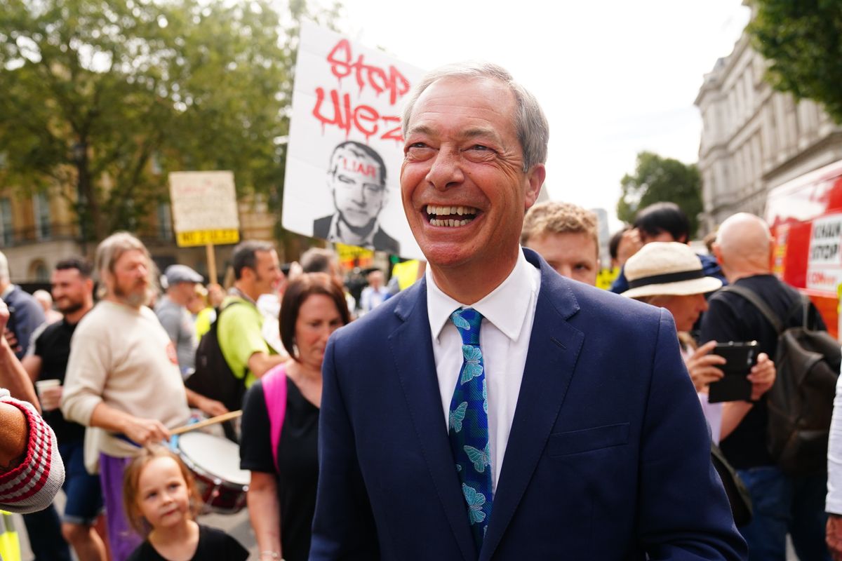 Nigel Farage speaks with protesters outside Downing Street in central London