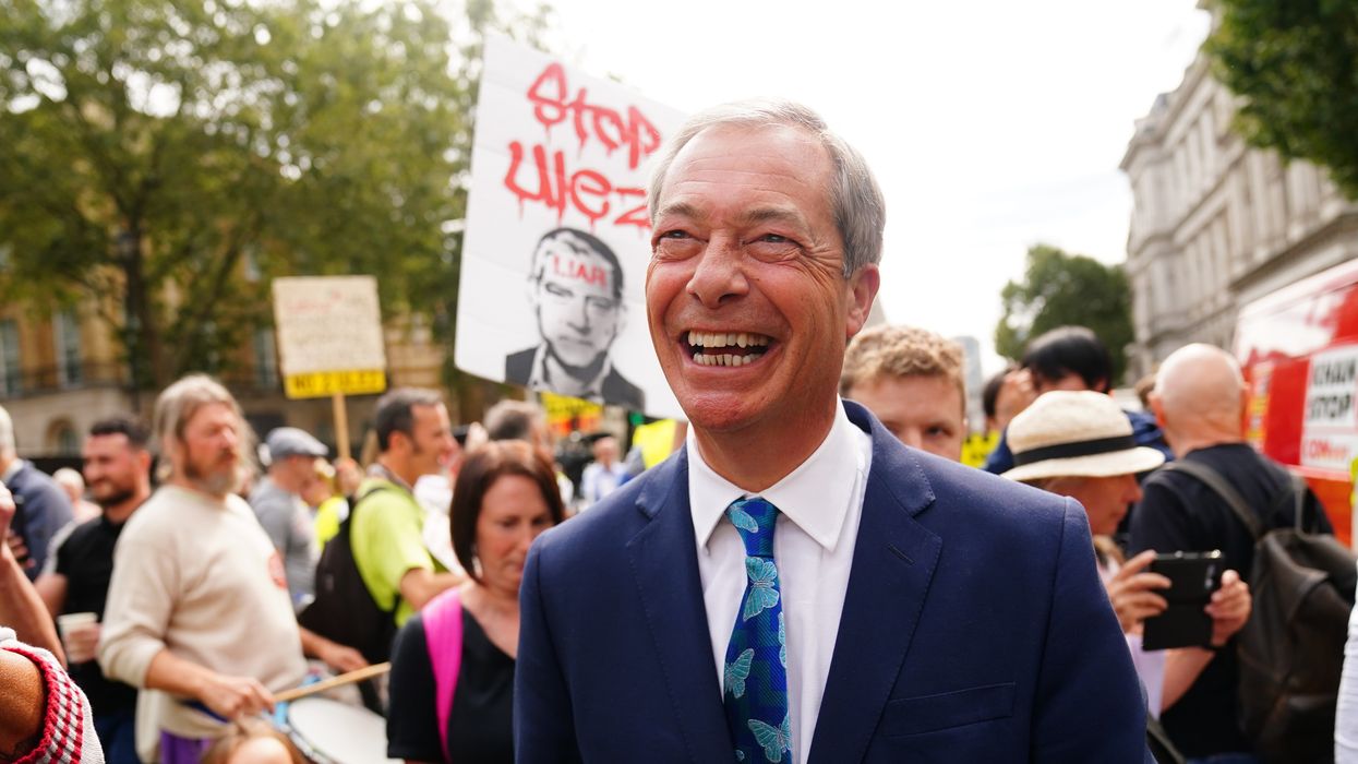 Nigel Farage speaks with protesters outside Downing Street in central London