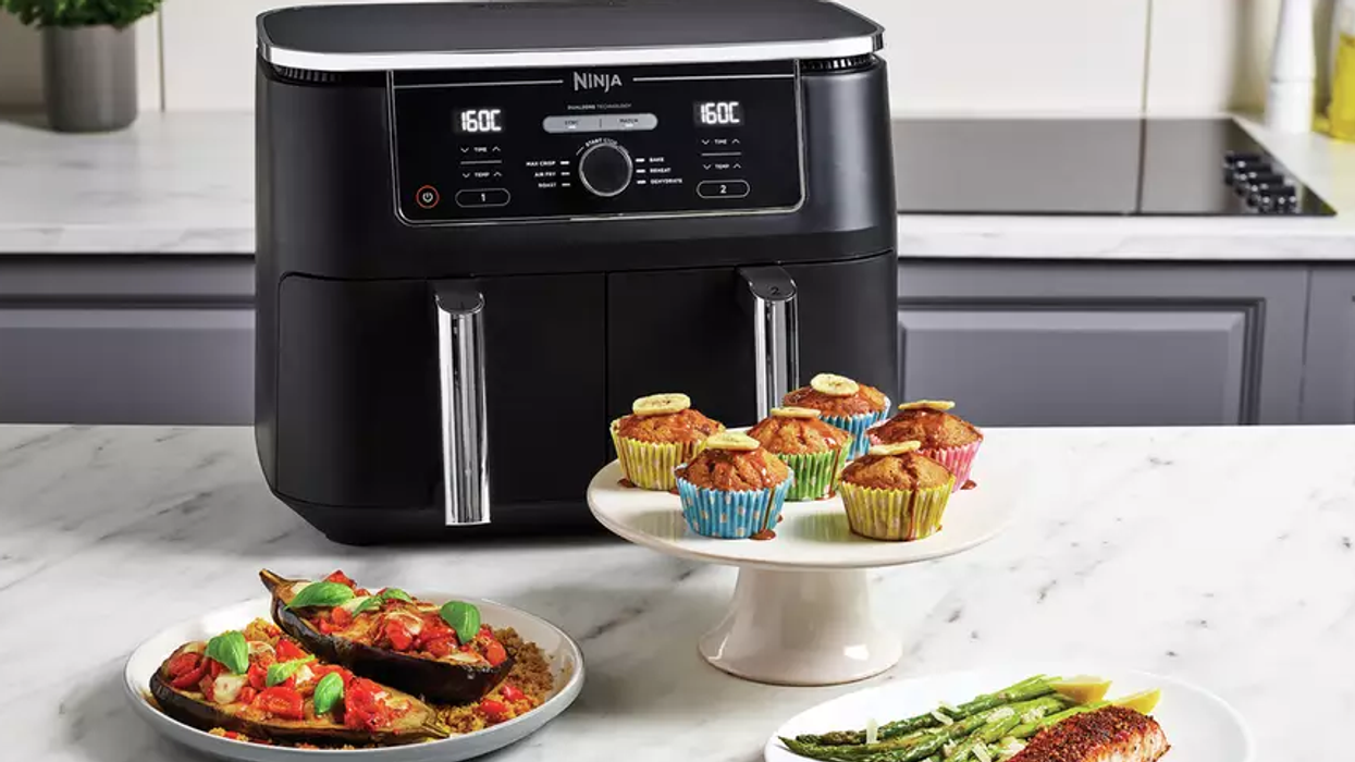 Ninja Foodi Max Dual Zone air fryer with freshly prepared food displayed