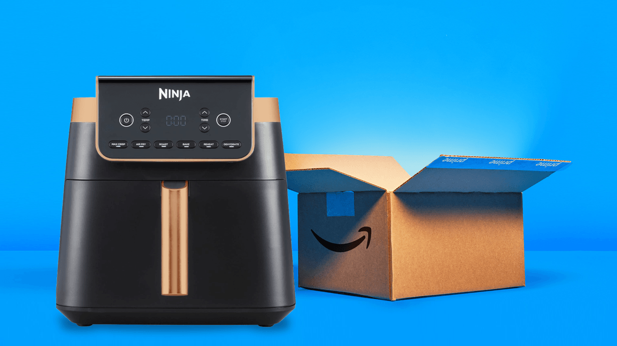 ninja max air fryer pictured in black and copper in front of an amazon shipping box