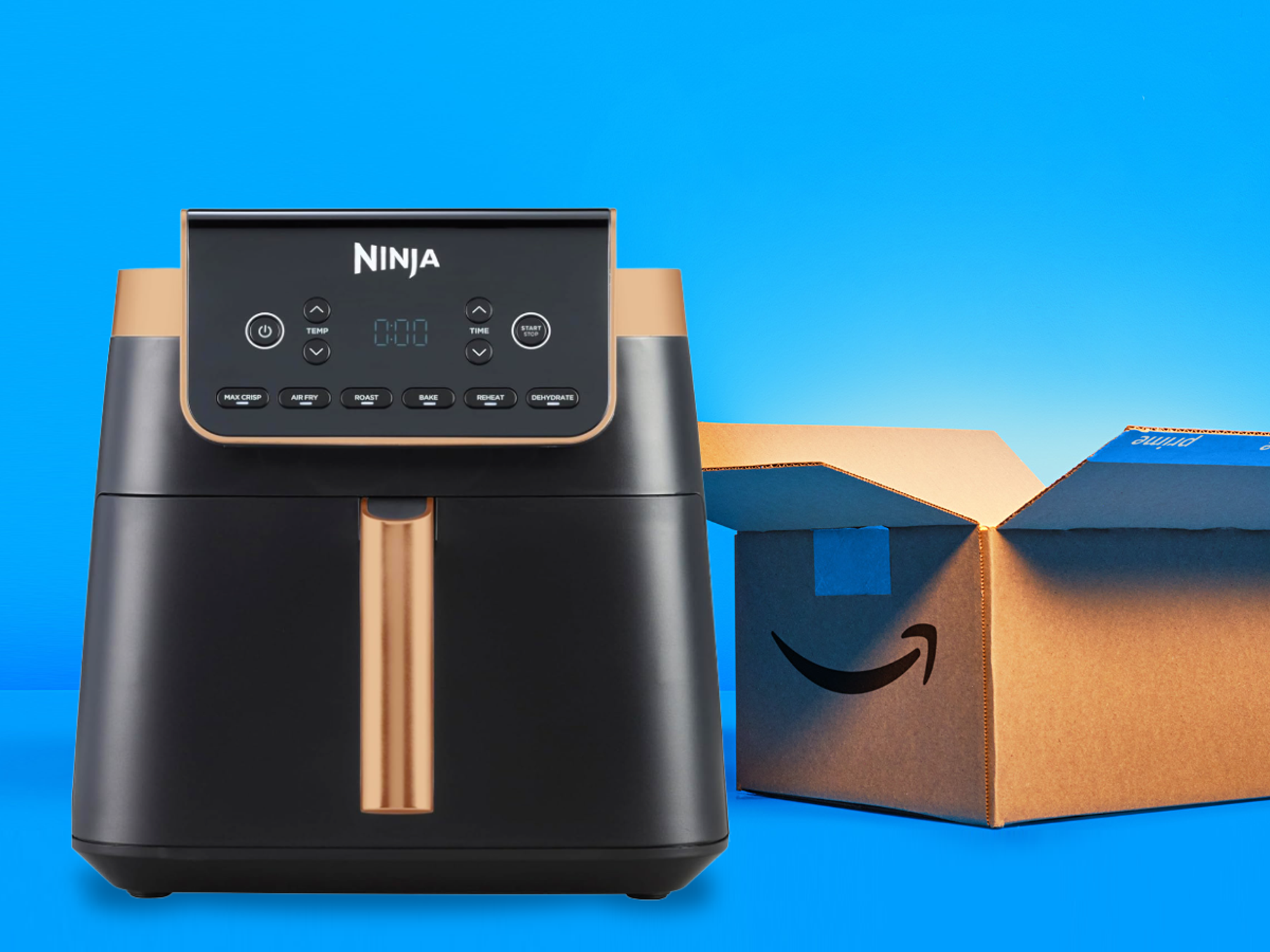 ninja max air fryer pictured in black and copper in front of an amazon shipping box