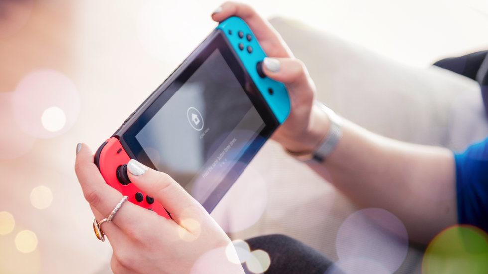 nintendo switch console in someones hands